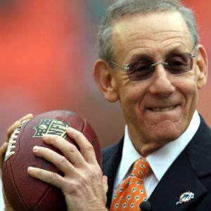 Stephen Ross holding a football