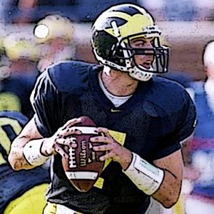 Drew Henson in U of M uniform holding a footback