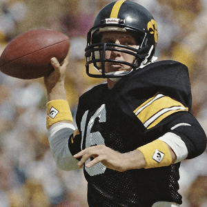 Chuck Long throwing a football