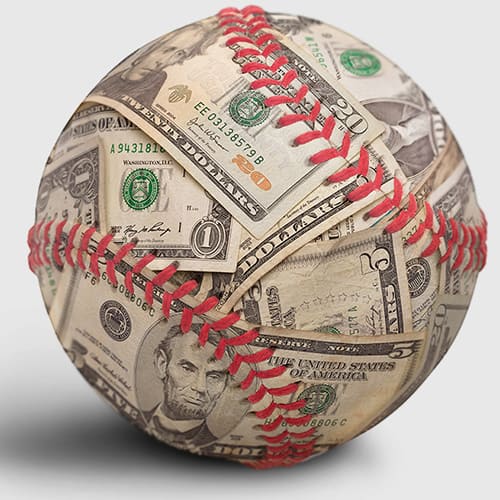 Baseball covered in dollar bills with red stitching