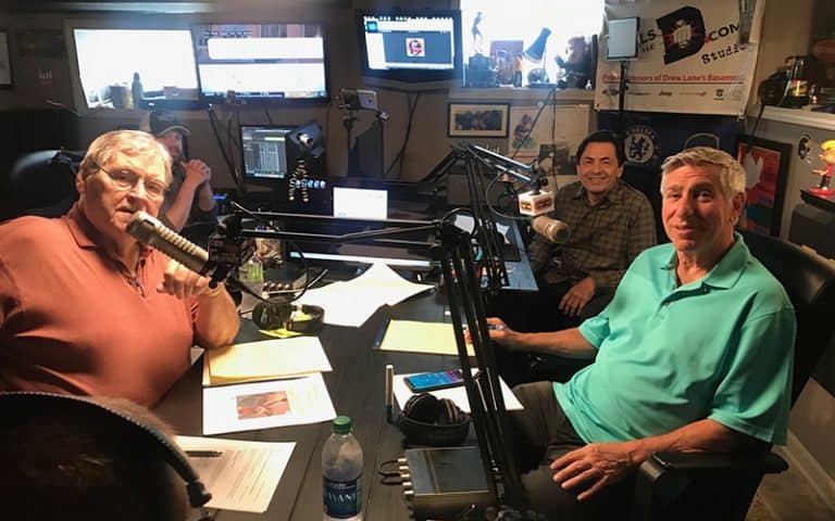 Photo of Denny, Bob and Eli around the table in the recording studio.